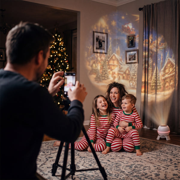 Family in matching pyjamas posing for a photo in front of a wall lit by the Novum Christmas Projection Light
