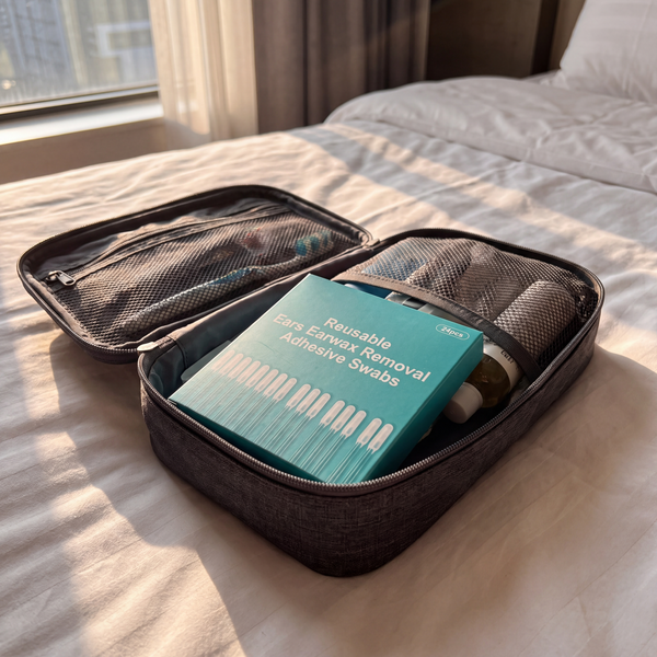 Box of earwax swabs in an open travel toiletry bag