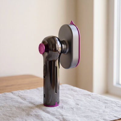 The Novum Mini Steam Iron standing on a linen cloth
