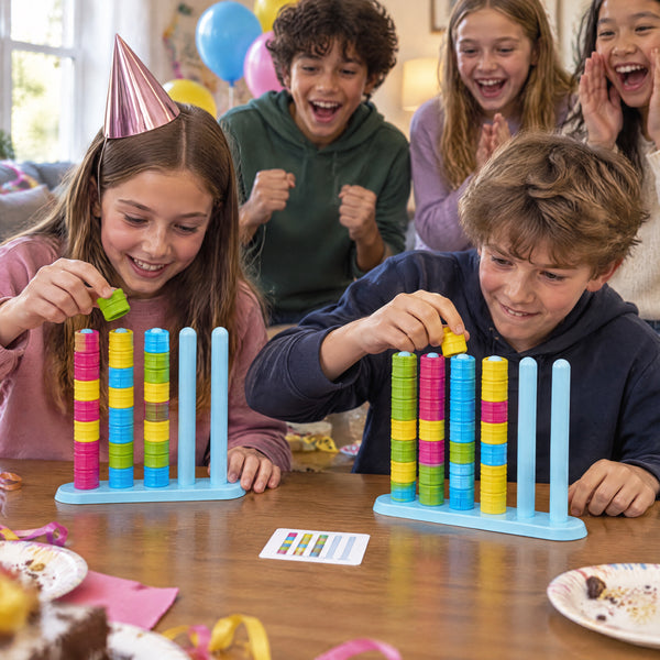 Children at a birthday party cheering on two players racing on the ring stack game