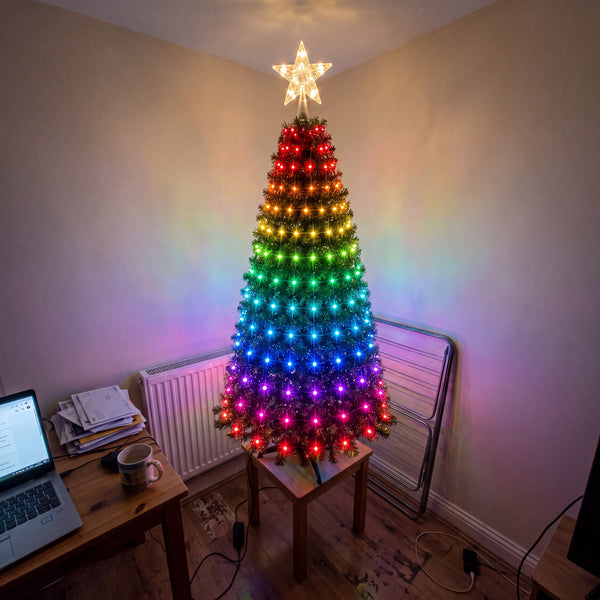 Multicolour tree lights on a small Christmas tree in a flat