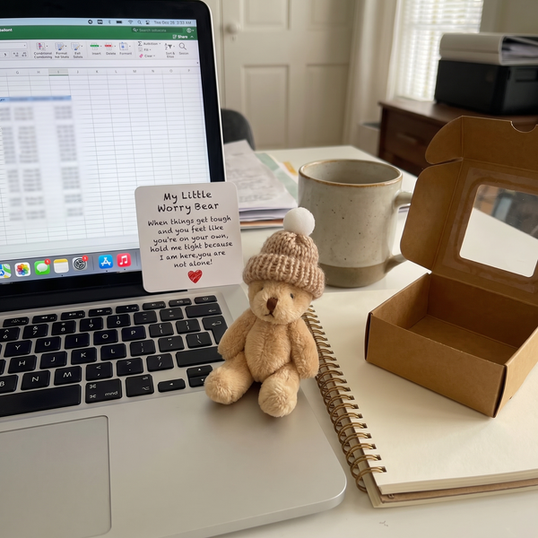 Novum Worry Bear on a laptop keyboard at a home desk