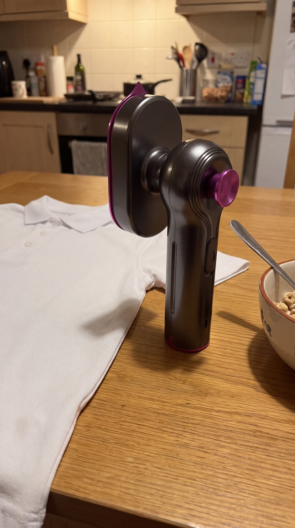 The Novum Mini Steam Iron next to a pressed school polo on a kitchen table